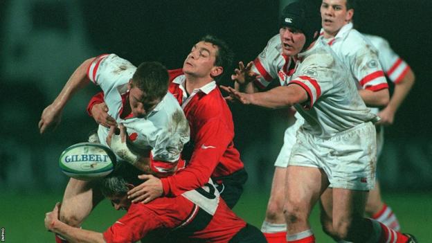 Jonny Bell attempts to make ground for Ulster as Tony McWhirter is in close attendance